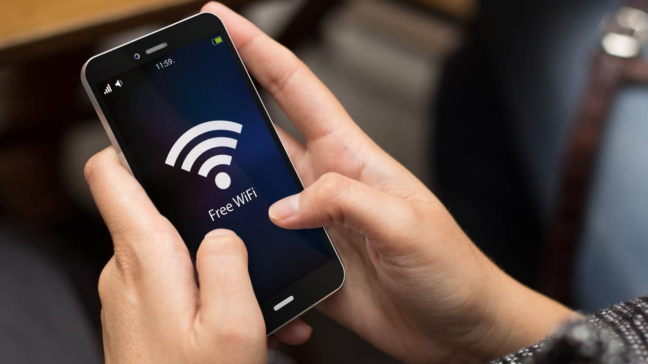 dettaglio mani femminili con smartphone collegato al wifi